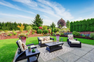 Impressive backyard landscape design with concrete patio area