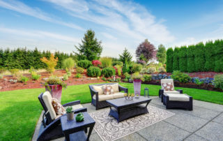 Impressive backyard landscape design with concrete patio area
