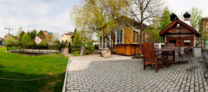 high-end brick backyard with paved patio area