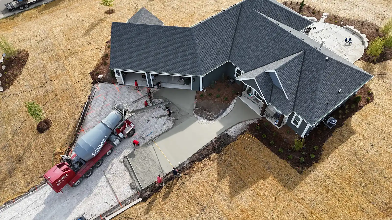 Aerial view of the JBS crew placing concrete for a residential driveway