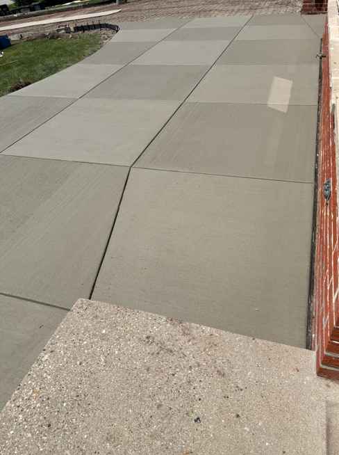 Freshly finished concrete driveway with clean edges and control joints in Germantown
