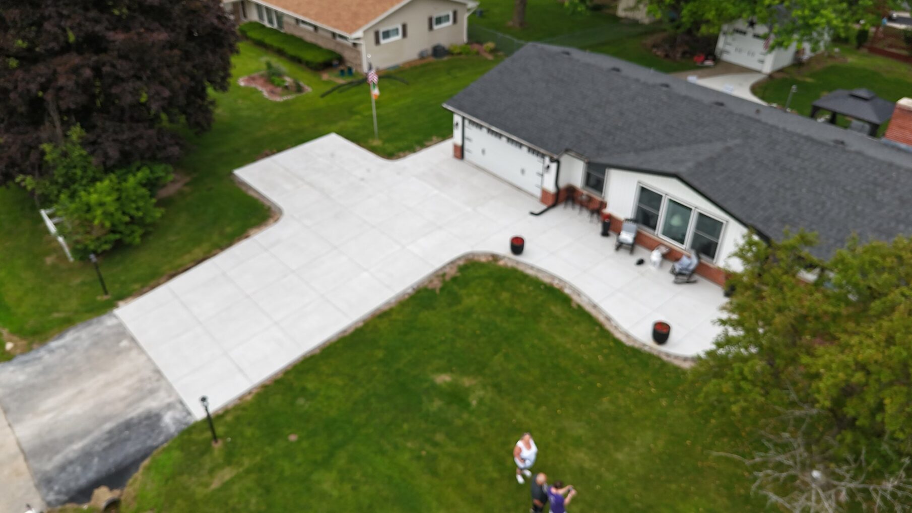 An aerial look at the driveway, front walk, and entry.