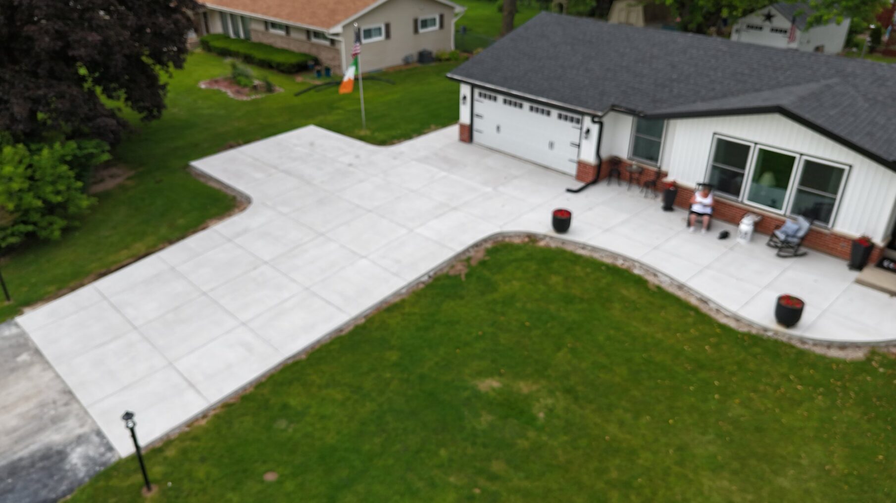 jbs-germantown-dji-fly-20250626-160042-0065-1750985427406-photo Aerial view of a new concrete driveway and walkway installed by JBS Construction in Germantown, WI