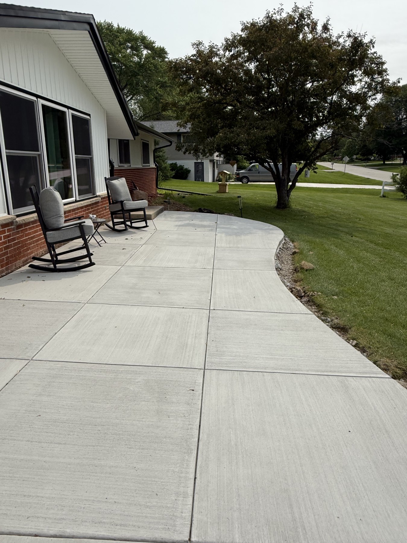 Curved concrete walkway leading to the front door